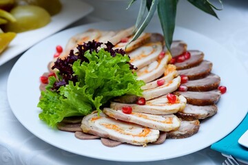 Meat cuts on a plate. Beautiful serving of food in a restaurant.