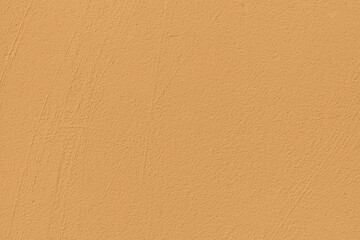 Saturated pastel orange colored low contrast Concrete textured background. Empty colourful wall texture with copy space for text overlay and mockups. 2023, 2024 color trend