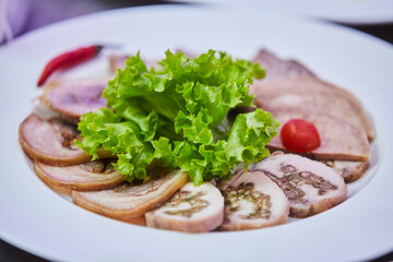 Meat cuts on a plate. Beautiful serving of food in a restaurant.