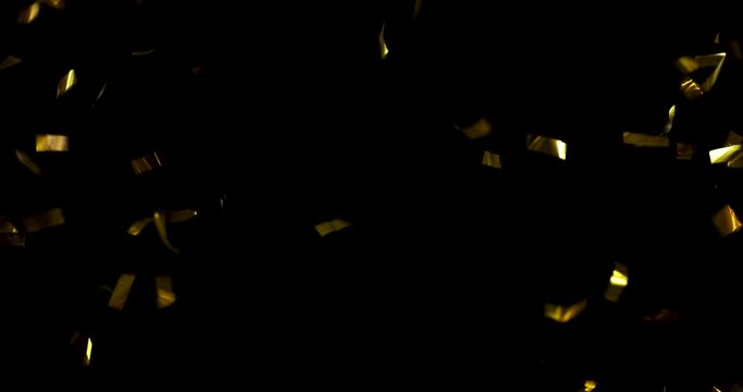 Falling foil confetti with gold glitter on a black background.