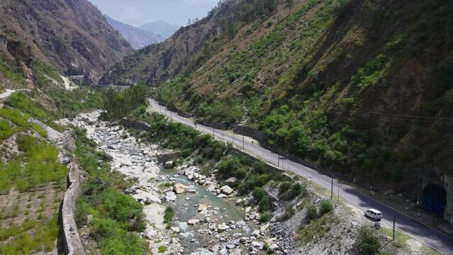 Drone Shot of a small road and river in Himachal Pradesh near Manali, Kasol