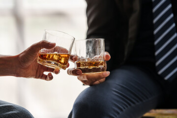 Sad depressed addicted drunk guy, Alone asian man drinker alcoholic sitting at bar counter with glass drinking whiskey. with friends.