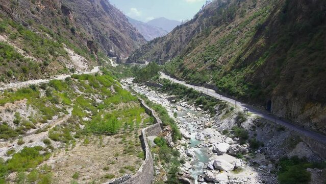 Drone Shot of a small road and river in Himachal Pradesh near Manali, Kasol