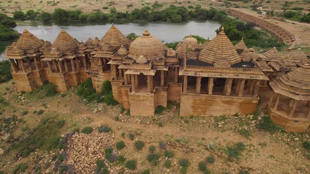 Hillside Bada Bagh Temple In Jaisalmer Beside Lake. Aerial Dolly Left