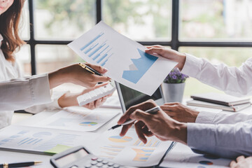 Young colleagues discuss business brainstorming and price charts analyze business people at the desk brilliantly in modern collaborative office teamwork ideas. Calculate personal tax for customers