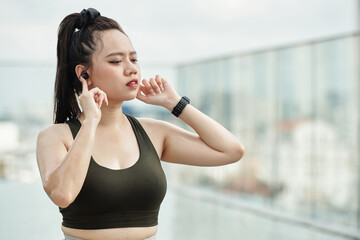 Sportswoman Listening to Music