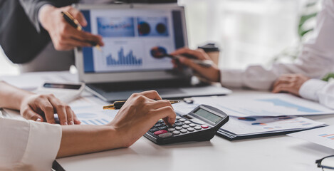 Young colleagues discuss business brainstorming and price charts analyze business people at the desk brilliantly in modern collaborative office teamwork ideas. Calculate personal tax for customers