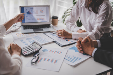 Young colleagues discuss business brainstorming and price charts analyze business people at the desk brilliantly in modern collaborative office teamwork ideas. Calculate personal tax for customers