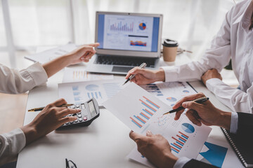 Young colleagues discuss business brainstorming and price charts analyze business people at the desk brilliantly in modern collaborative office teamwork ideas. Calculate personal tax for customers