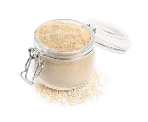 Glass jar of sesame flour isolated on white