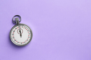 Vintage timer on violet background, top view. Space for text