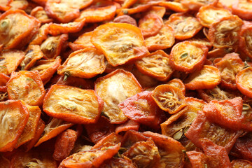 Cut dried kumquat fruits as background, closeup