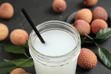 Freshly made lychee juice on grey table, closeup
