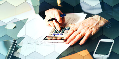 Hand using calculator, accounting concept, geometric pattern