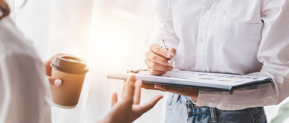 Fototapeta premium Young colleagues discussing business and price chart analyzes business people on the table great in modern coworking office teamwork concept. Calculate personal tax for customers