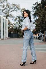 Young stylish woman Portrait woman in jeans on street