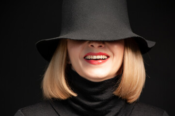 Woman in black dress and hat on background