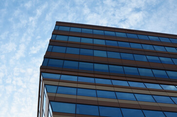Fototapeta na wymiar Modern building against blue sky, low angle view