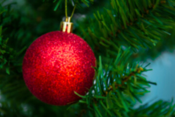 Obraz na płótnie Canvas Blurred red bon that decorates the Christmas tree background.