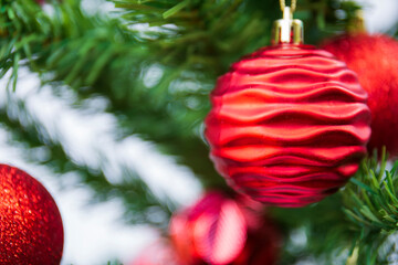 Red balls decorated on the Christmas tree.