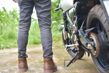 Biker with motobilk on nature background.