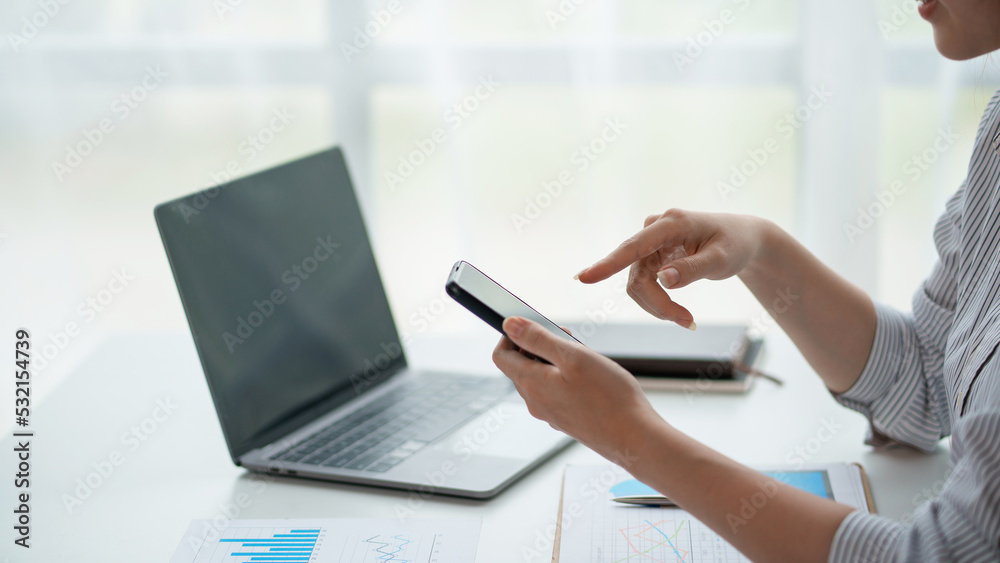 Wall mural close-up of a woman using a smartphone to work on various social media applications. including mobil
