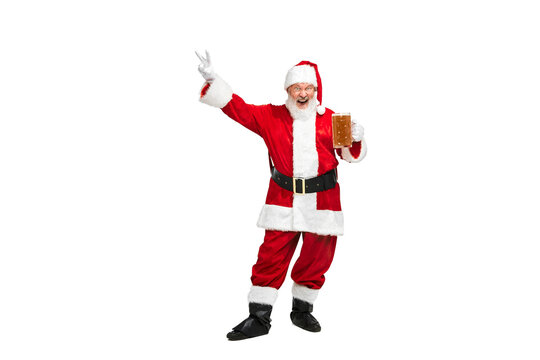 Portrait of senior man in image of Santa Claus posing with glass of lager foamy beer isolated over white background