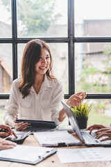 Young colleagues discussing business and price chart analyzes business people on the table great in...