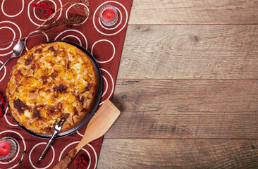 Homemade yellow plum pie on rustic background, top view, copy space. Classic autumn Thanksgiving dessert - organic pie