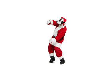 Portrait of senior man in image of Santa Claus posing in VR glasses isolated over white background