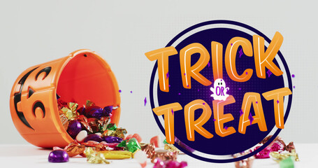 Image of halloween text over carved pumpkin bucket with sweets on grey background