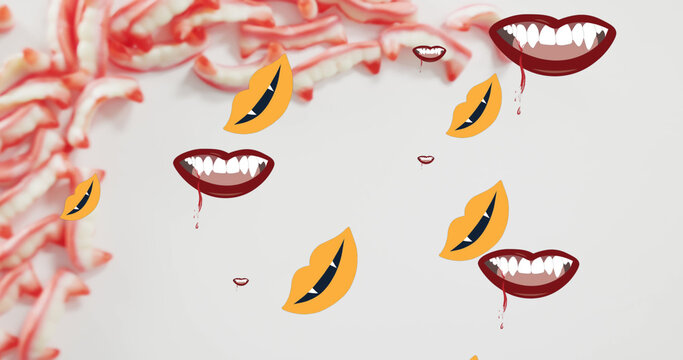 Image of halloween vampire teeth moving over sweets on grey background