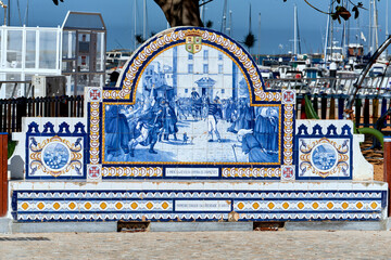 azulejo panels on a stone bench telling of maritime life in Olhao, Faro district Algarve, Portugal