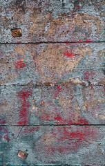 Gray concrete wall with paint and dirt stains, grungy vintage background closeup, grunge texture.