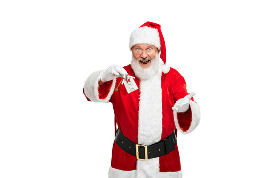Portrait of senior man in image of Santa Claus with new apartment keys isolated over white background