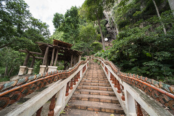 This is the temple of  Wat Tham Khao Chaka, at Sa Kaeo in Thailand. The stairs at the end are very steep and there are monkeys.