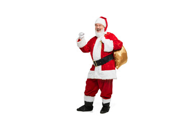 Portrait of senior man in image of Santa Claus posing with big golden box for presents isolated over white background