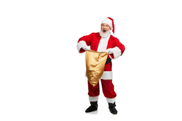 Portrait of senior man in image of Santa Claus posing with big golden box for presents isolated over white background