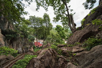 This is the temple of  Wat Tham Khao Chaka, at Sa Kaeo in Thailand. The stairs at the end are very steep and there are monkeys.