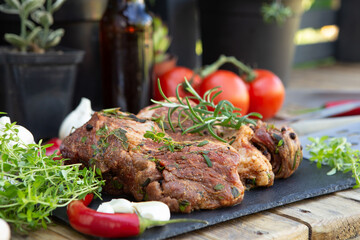 Marinated beef steak on wooden table top. Healthy food concept. Beef cut and spices for cooking bbq sauce outdoors, garden kitchen