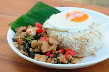 Fast food, popular in Thailand, chicken basil rice, boiled egg, arranged by using banana leaves to enhance the original taste.
