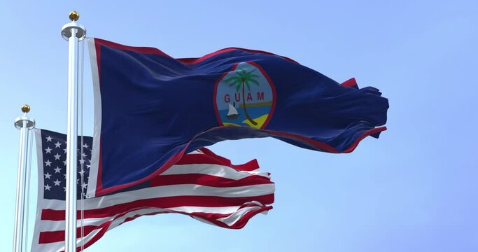 Flag of Guam waving in the wind with the US flag on a clear day