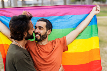 Happy couple with a pride flag. LGBT community