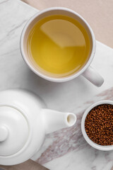 Obraz na płótnie Canvas Freshly made buckwheat tea and granules on table, top view