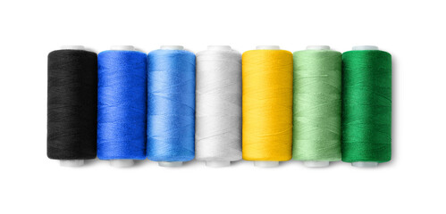 Set of different colorful sewing threads on white background, top view