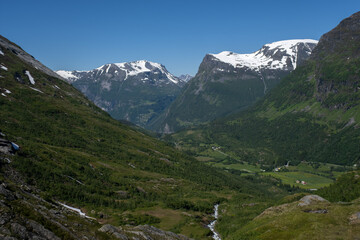 Wonderful landscapes in Norway. Vestland. Beautiful scenery of mountain valley in Djupevatn on the Geiranger -Trollstigen scenic route. Snowed mountains and winding roads in background Selective focus