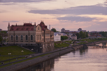 View of the Volga River and the embankment of the city of Rybinsk from the bridge at sunset.