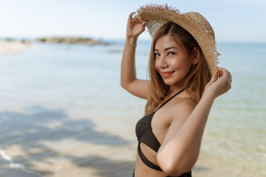 portrait of a woman in a straw hat landscape tan on the beach