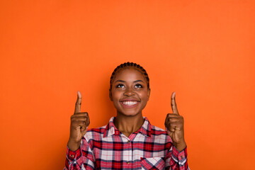 Photo of thoughtful cute lady wear checkered shirt looking pointing up empty space isolated bright...