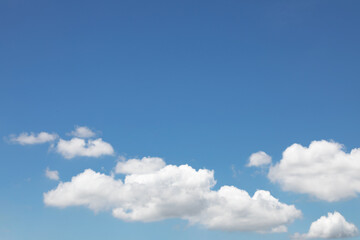 Blue sky background and white clouds soft focus, and copy space horizontal shape.